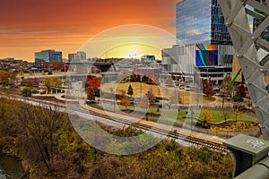 A shot of a gorgeous autumn landscape with the skyscrapers and the office buildings in the cityscape from the bridge