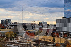 A shot of a gorgeous autumn landscape with the skyscrapers and office buildings in the cityscape from the bridge