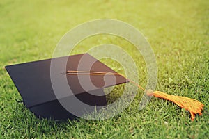 Shot of graduation hat on the grass, concept during commencement success graduates of the university, education congratulation. Le