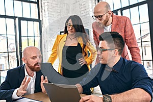 Shot of a group of young business professionals having a meeting. Diverse group of young designers smiling during a