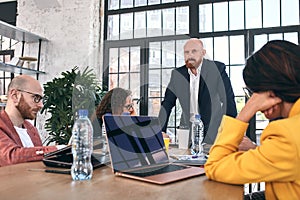 Shot of a group of young business professionals having a meeting. Diverse group of young designers smiling during a