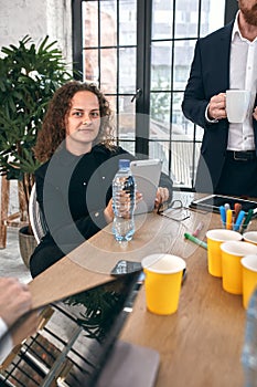 Shot of a group of young business professionals having a meeting. Diverse group of young designers smiling during a