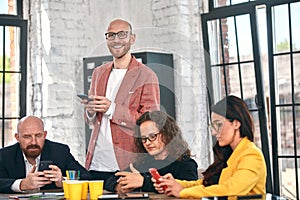 Shot of a group of young business professionals having a meeting. Diverse group of young designers smiling during a