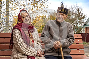 Shot of a happy elderly  asians couple sitting    on a bench on the street