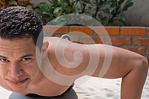 A shot of a hispanic athlete doing a push-up