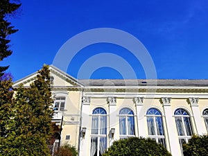 Shot of the hotel wall slightly closed by a tree in Spa, Park Jelenia GÃ³ra, Poland.