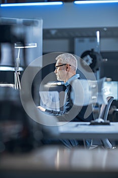 Shot of Industrial Engineer Working in Research Laboratory / Development Center, Using Computer. H