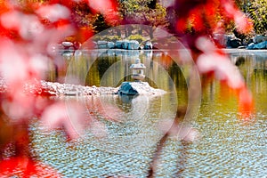 Shot of the lantern statue shot through the trees at the japanese garden in the Frederik Meijer Gardens