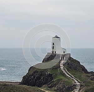 Shot of the lighthouse on the cliff  in Ynys Llanddwyn, Anglesey, Wales photo