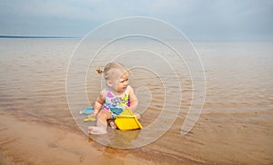 Shot of a little child playing on the lake