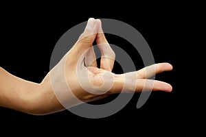 Shot of a male hand demonstrating Prana Mudra isolated on black background. photo