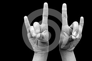 Shot of male hands demonstrating Apana mudra with two hands isolated on a black background. photo