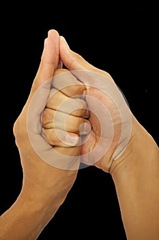 Shot of male hands doing Shankh mudra isolated on black background.