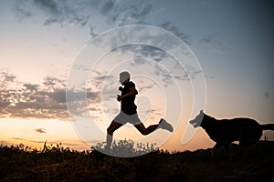 Shot of a male running and training with the dog