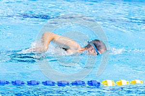 shot of a man swimming in a pool during competition