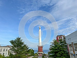 Shot of manado city's candle statue photo
