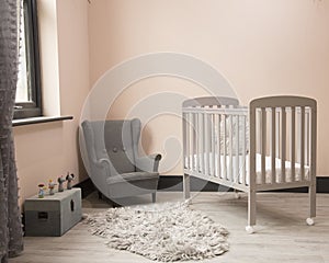 Shot of minimalistic sunny baby\'s room interior with child\'s bed