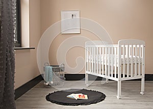 Shot of minimalistic sunny baby\'s room interior with child\'s bed