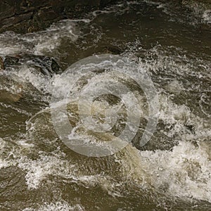 shot of a mountain stream swollen with water due to heavy rains