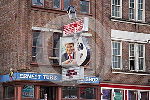 A shot of the neon sign outside of Ernest Tubb Record Shop along Broadway street on a cloudy day in Nashville Tennessee