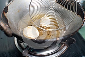 Shot of north indian street food snack gol gappe pani puri or puchke being fried from dough in hot oil to make them