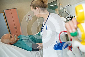 Shot nurse checking on senior patient