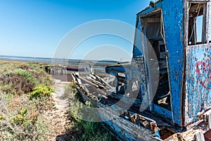 Shot of an old abandoned boat on the low tide shore of Cais PalafÃ­tico da Carrasqueira, Portugal