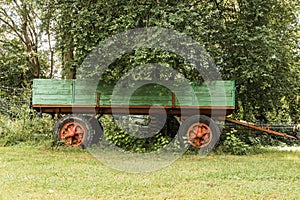 Shot of old tractor-trailer on the greenery background