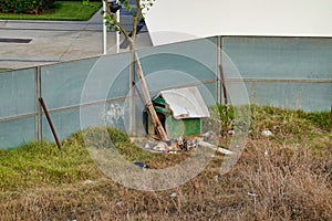 Shot of an old wooden dogshed and a little doggie lying in the dirty homeyard