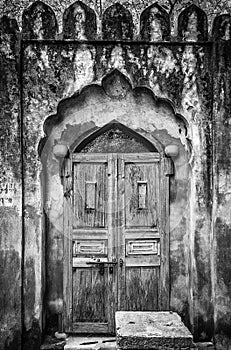 A shot of old wooden doors bolted together