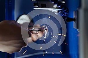 Shot of optician technician hands repair frame of glasses in the plant