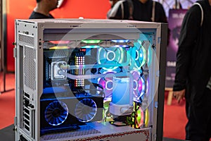 shot of overclocked CPU computer cabinet with water liquid cooled processors and RGB red green blue lighting with metal