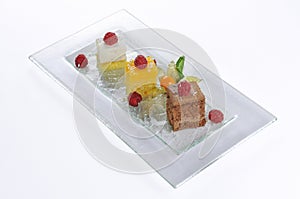  shot of a plate with three small cakes for degustation
