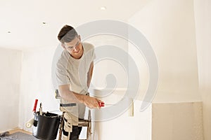Shot of professional contractor painter refurbishing the apartment photo