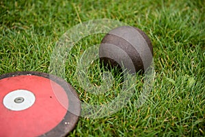 Shot put ball and discus one the stadium