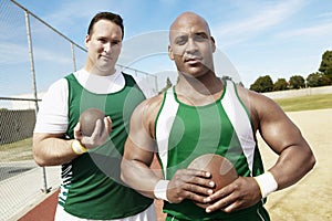 Shot Putters Holding Shot Put And Discus