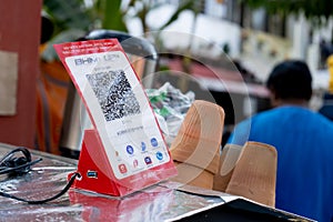 Shot of red lit QR code holder with BHIM code allowing UPI payment through popular payment apps like google pay, Paytm