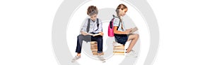 Shot of schoolkids sitting on books