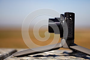 Compact camera on small tripod photo
