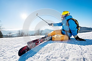 Skier resting on top of the mountain