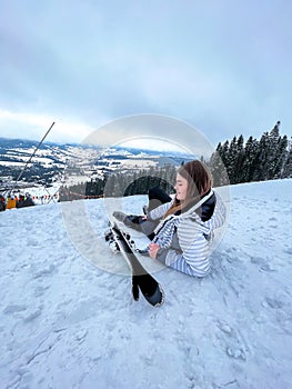 Shot of a skier woman sitting on the ski slope resting relaxing extreme recreation active lifestyle activity. Female