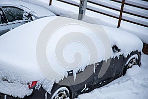 shot of snow-covered automobiles on a cold frozen day in winter