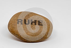 Shot of a stone with the german word Ruhe on it