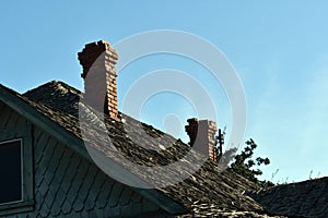 Shot of two chimneys made of stone under the blue sky