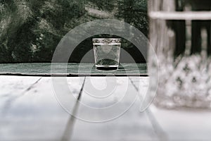 Shot of vodka and bottle on table. Concept of drinking alcohol, drinks in authentic bar