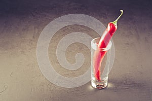 shot of vodka and red pepper/shot of vodka and red pepper on a dark background. Copyspace