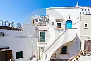 Shot of the white buildings with colorful aspects in Peschici, Italy