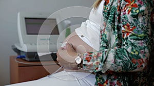 Shot of Woman during foetal heart monitor during check.