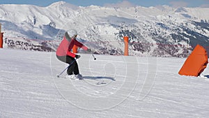 Shot of Woman Skis Carving Down The Slope In The Mountains Ski Resort At Winter