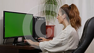 Shot of woman typing on laptop keyboard with green screen, Working from home, Home office person using laptop computer